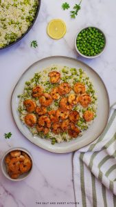 Shrimp and rice with peas in a white plate