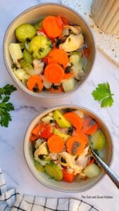 two bowls of hearty Lebanese soup with chicken and veggies.