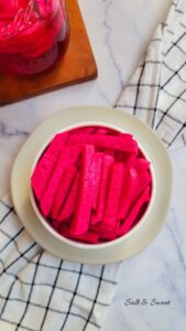Lebanese pickled turnip placed in a small white bowl over a kitchen towel
